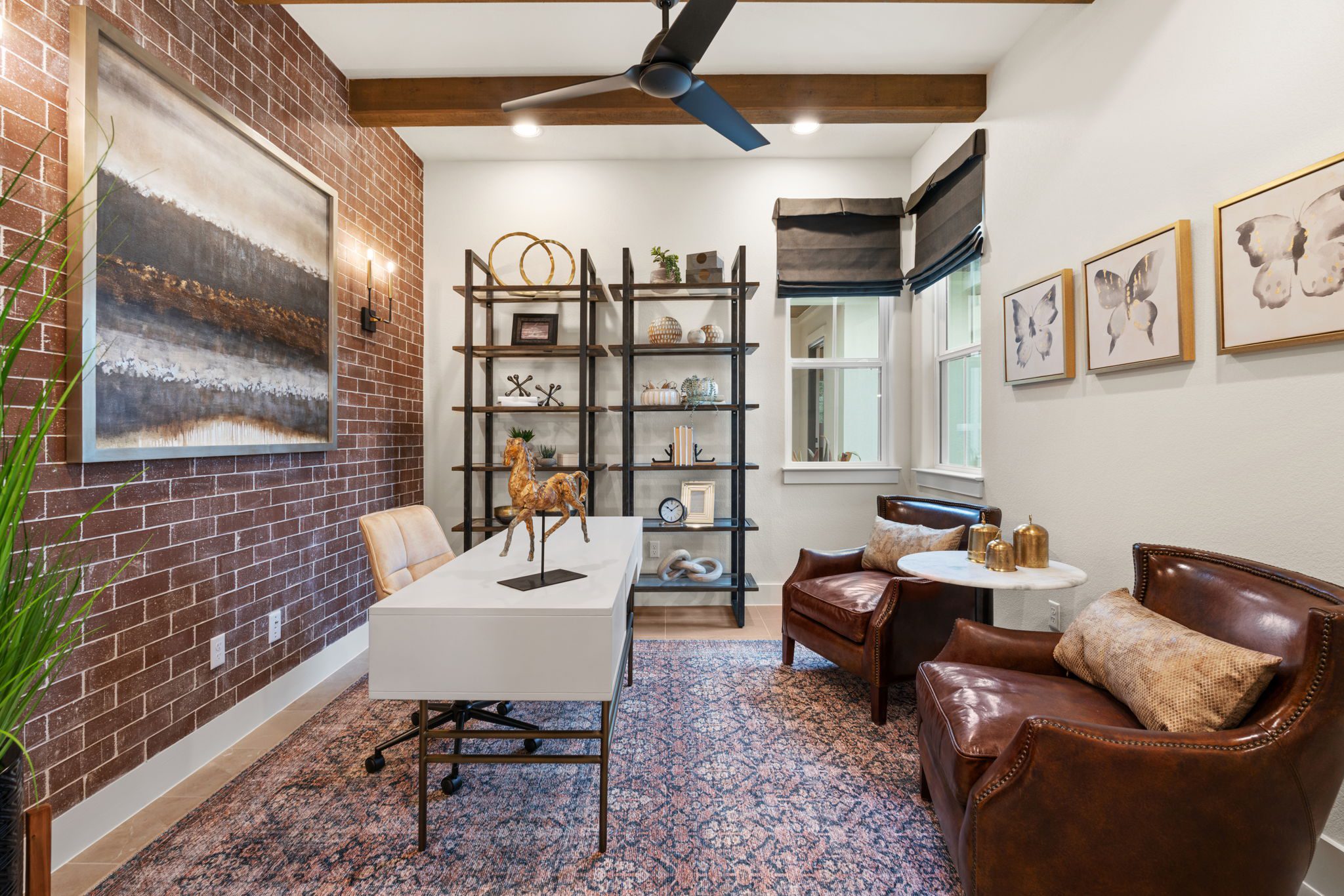Office with Brick Accent Wall and Leather Chairs